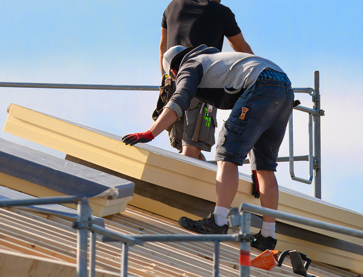 Image of work men installing roof insulation